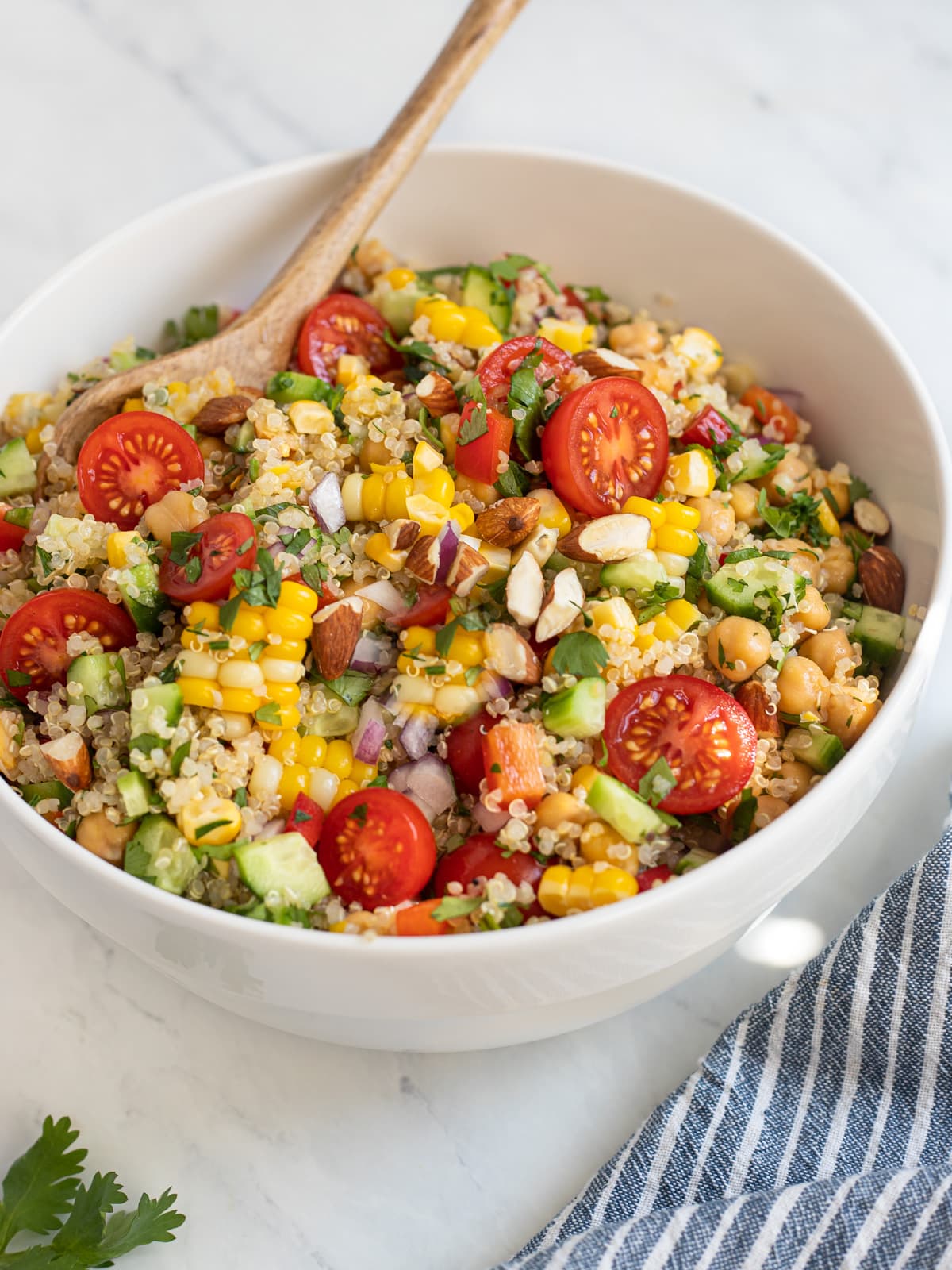 Bowl of quinoa and veggie salad with corn and tomatoes.