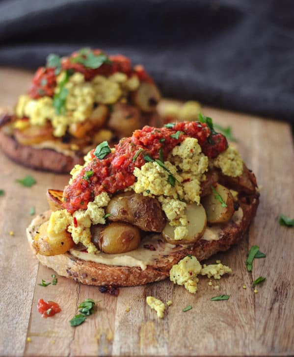 Curry tofu scramble on sourdough toast with potatoes and tomato chutney. Easy and delicious vegan meal.