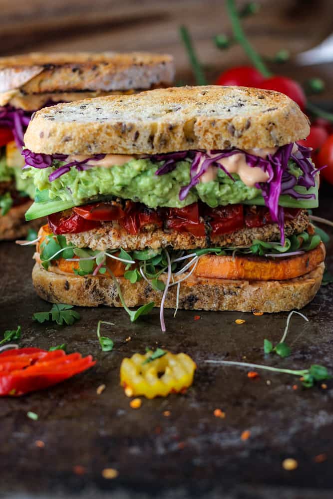 big vegetable, guacamole, and tofu sandwich on 2 slices of sourdough