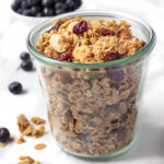 Jar of homemade granola with dried cranberries.