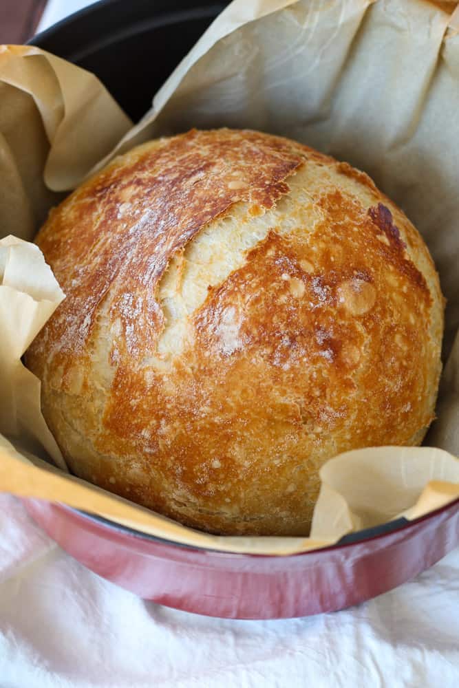 Round loaf of bread in Dutch oven.