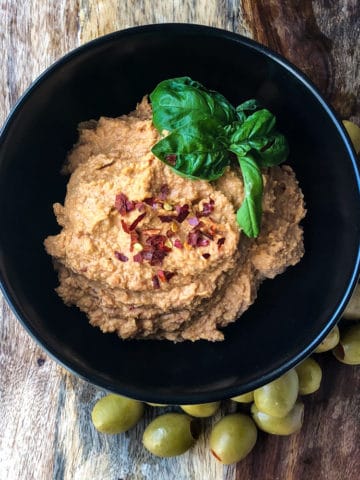 Tangy Tomato and Olive chickpea Hummus in a bowl