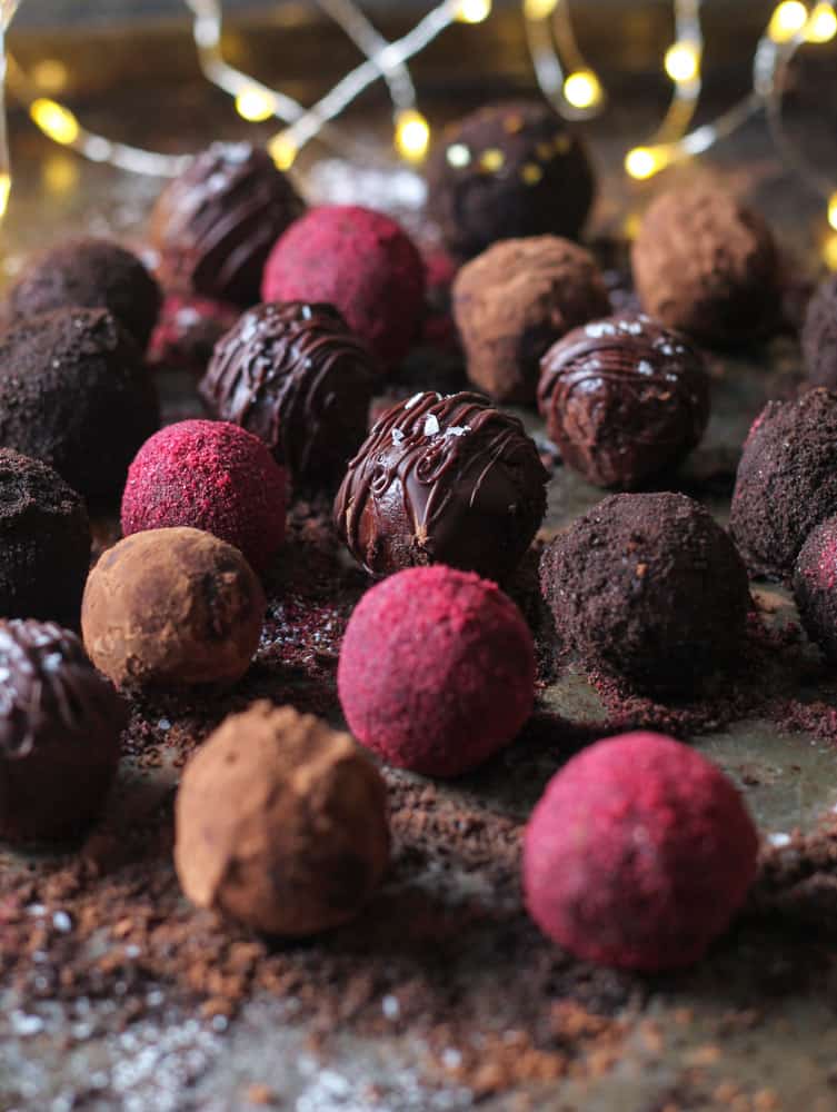 Tray of vegan mocha truffles coated in chocolate and raspberry sprinkles.