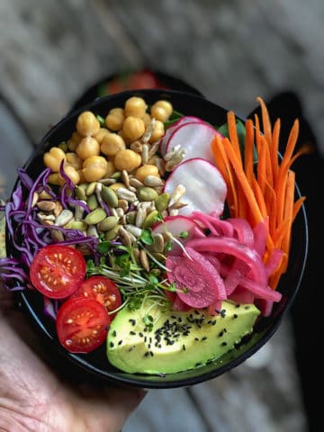 Bowlful of rainbow salad with chickpeas and avocado.