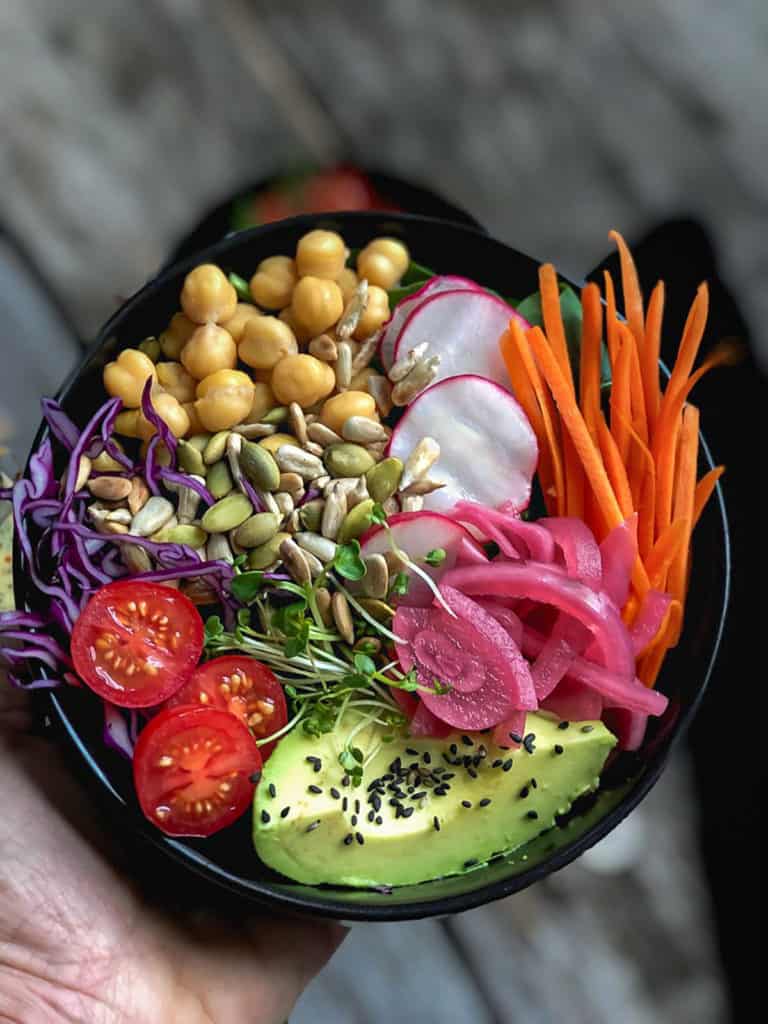 Bowlful of salad with chickpeas and avocado.