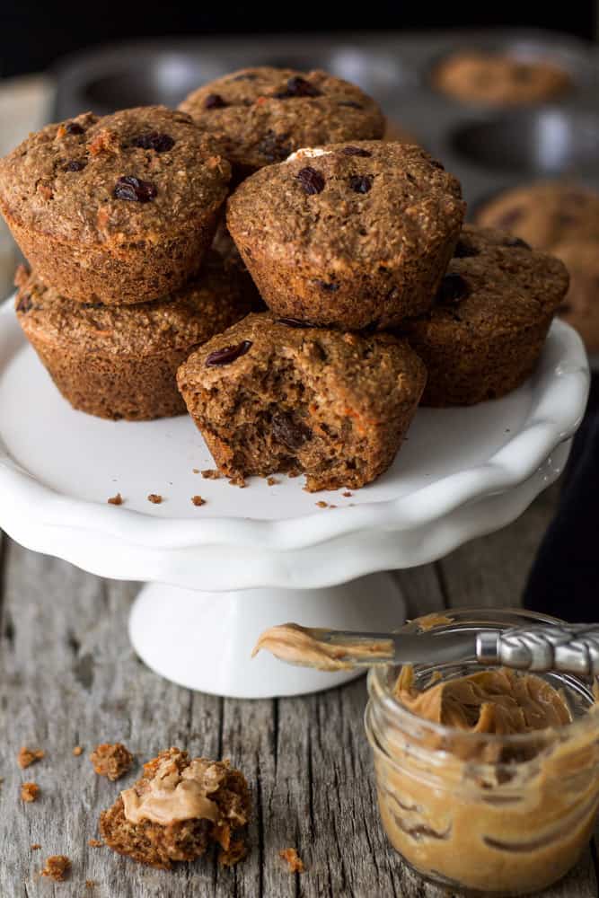 Carrot Raisin Bran Muffins piled up on cake stand.