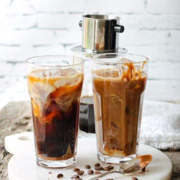Two tall glasses of dairy-free iced coffee with a drip of vegan caramel sauce.