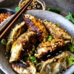 vegan potstickers with maple-soy dipping sauce served in a bowl