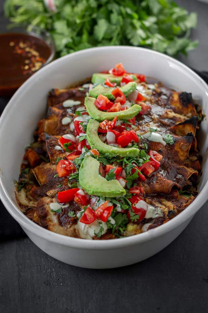 Spicy poblano mushroom enchiladas in a baking dish.