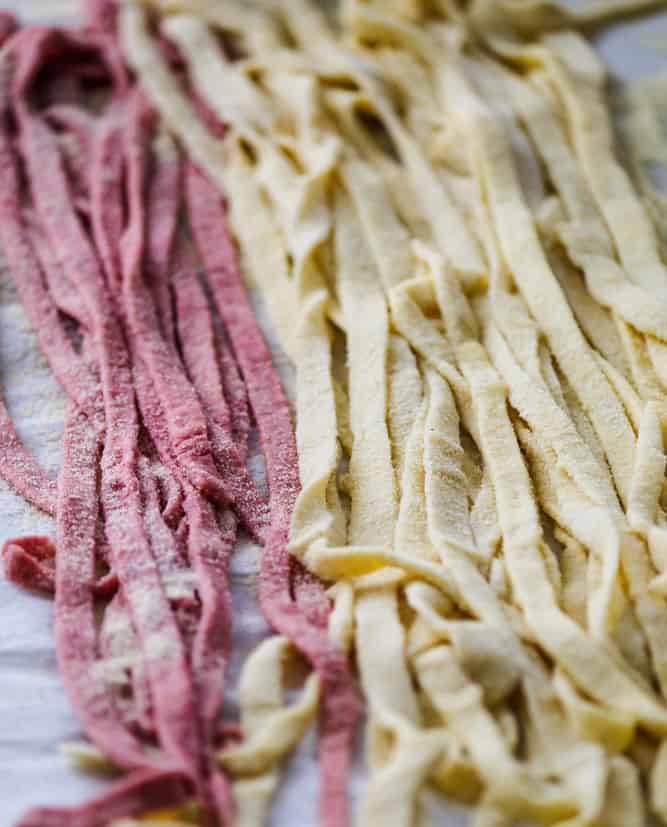 Freshly made fettuccine pasta resting on the counter.