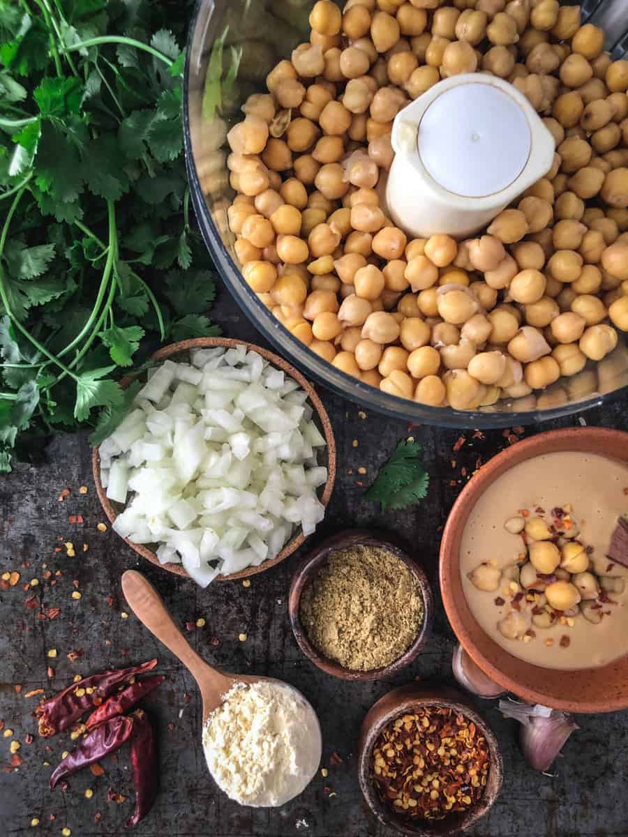 Ingredients for vegan falafel including chickpeas, onions, tahini and spices.