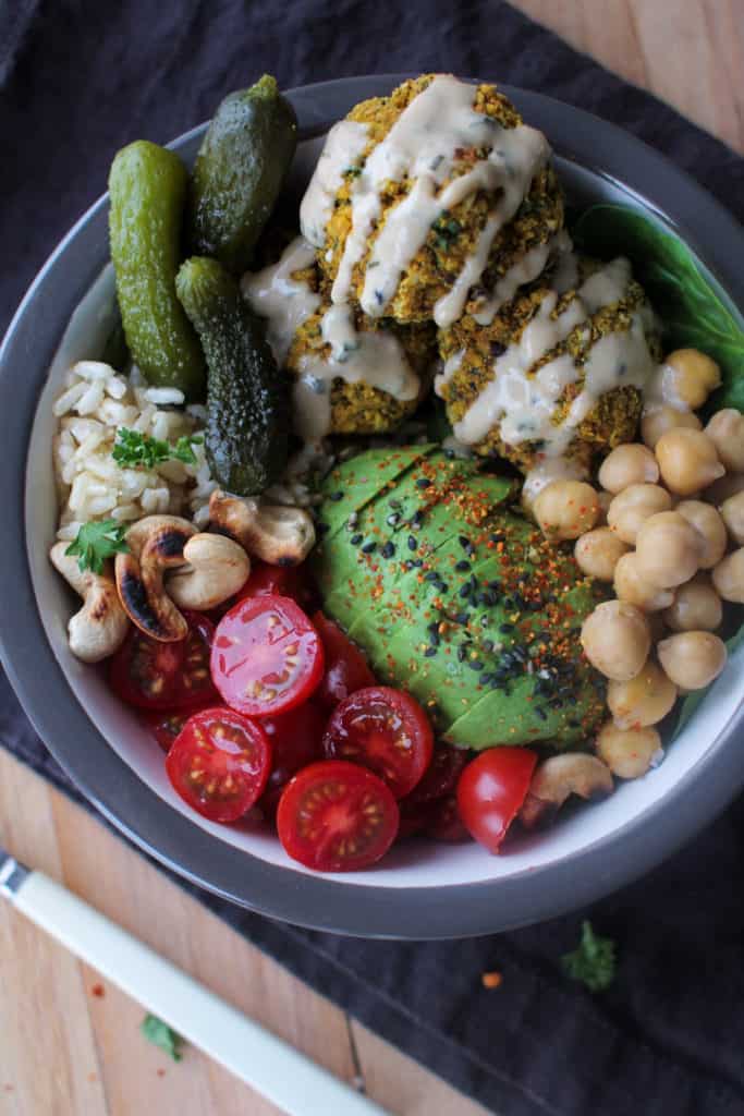 Easy falafel nourish bowl with avocado, rice and tomatoes.