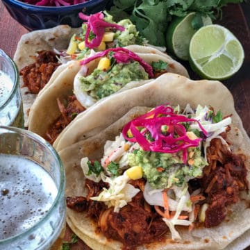 Jackfruit and tropical slaw tacos served with pickled onions and lime.