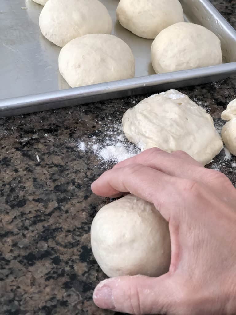 Easy beginner yeast rolls being shaped into balls.
