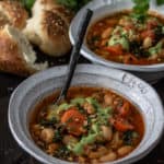 Two bowls of vegan vegetable bean soup with bun.