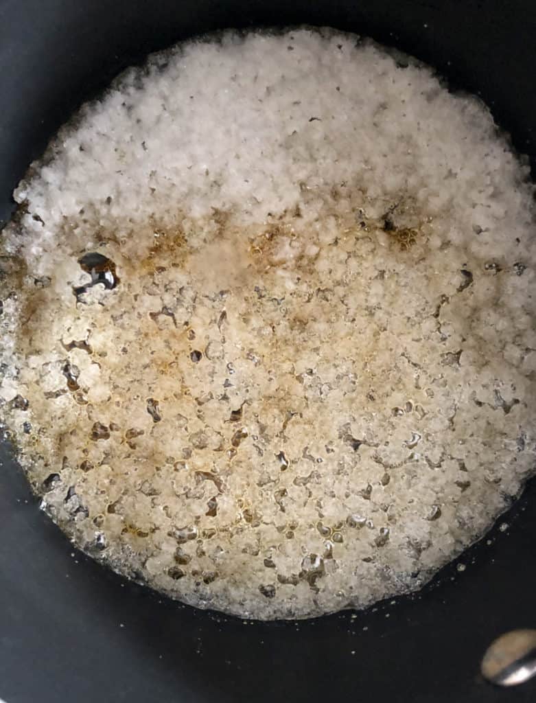 Sugar and water heating in a pan making caramel sauce.
