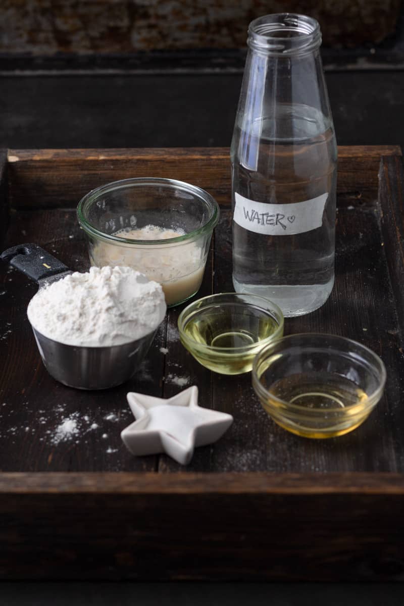 Ingredients for bread making laid out on tray.