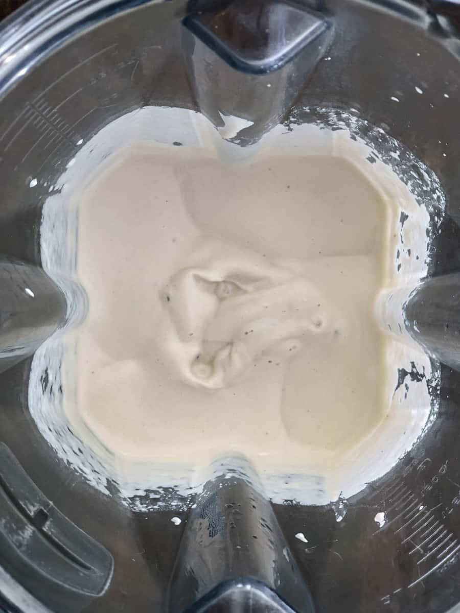 Close up of a blender of cashew cream sauce.