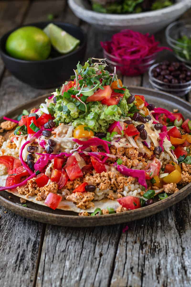 Taco Rice Bowl pile high with slaw, guacamole, and taco filling.