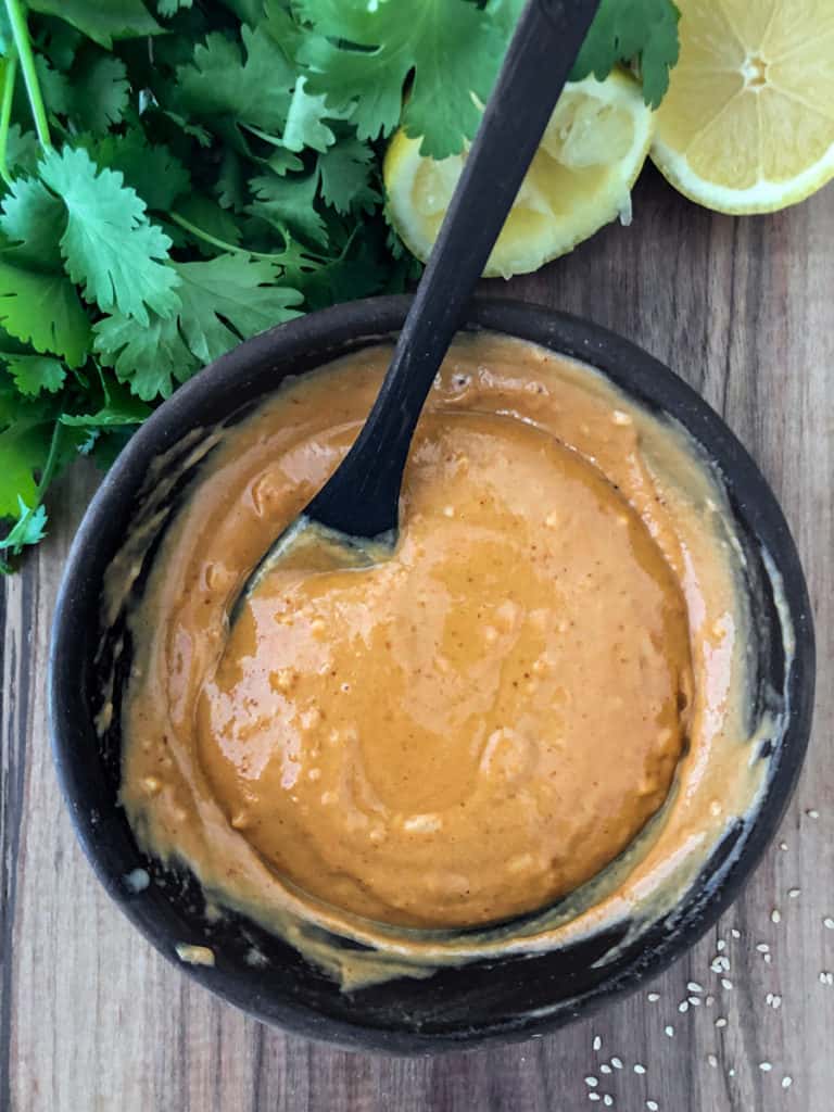 Thick sweet and spicy tahini sauce mixed in a bowl.