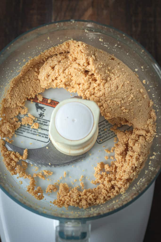 Peanut butter being blended in a food processor.