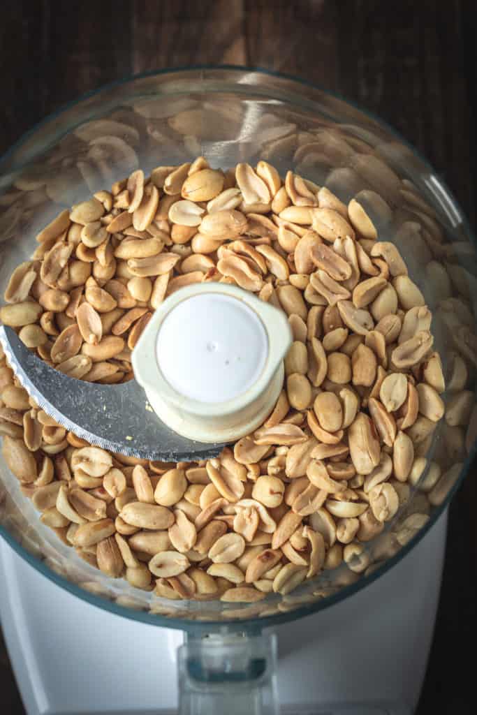 Roasted peanuts in a food processor bowl.
