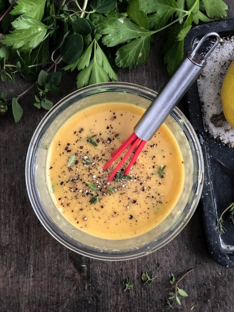 Dish of vegan honey mustard dressing being whisked.