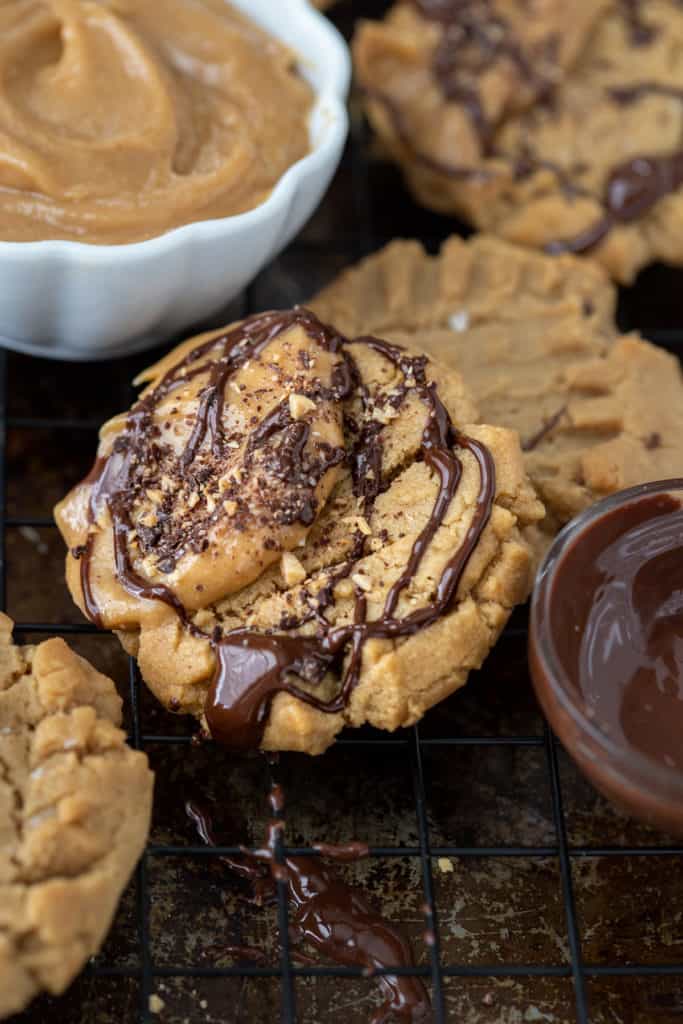 Cookie sheet with peanut butter cookies and bowl of whipped peanut butter.