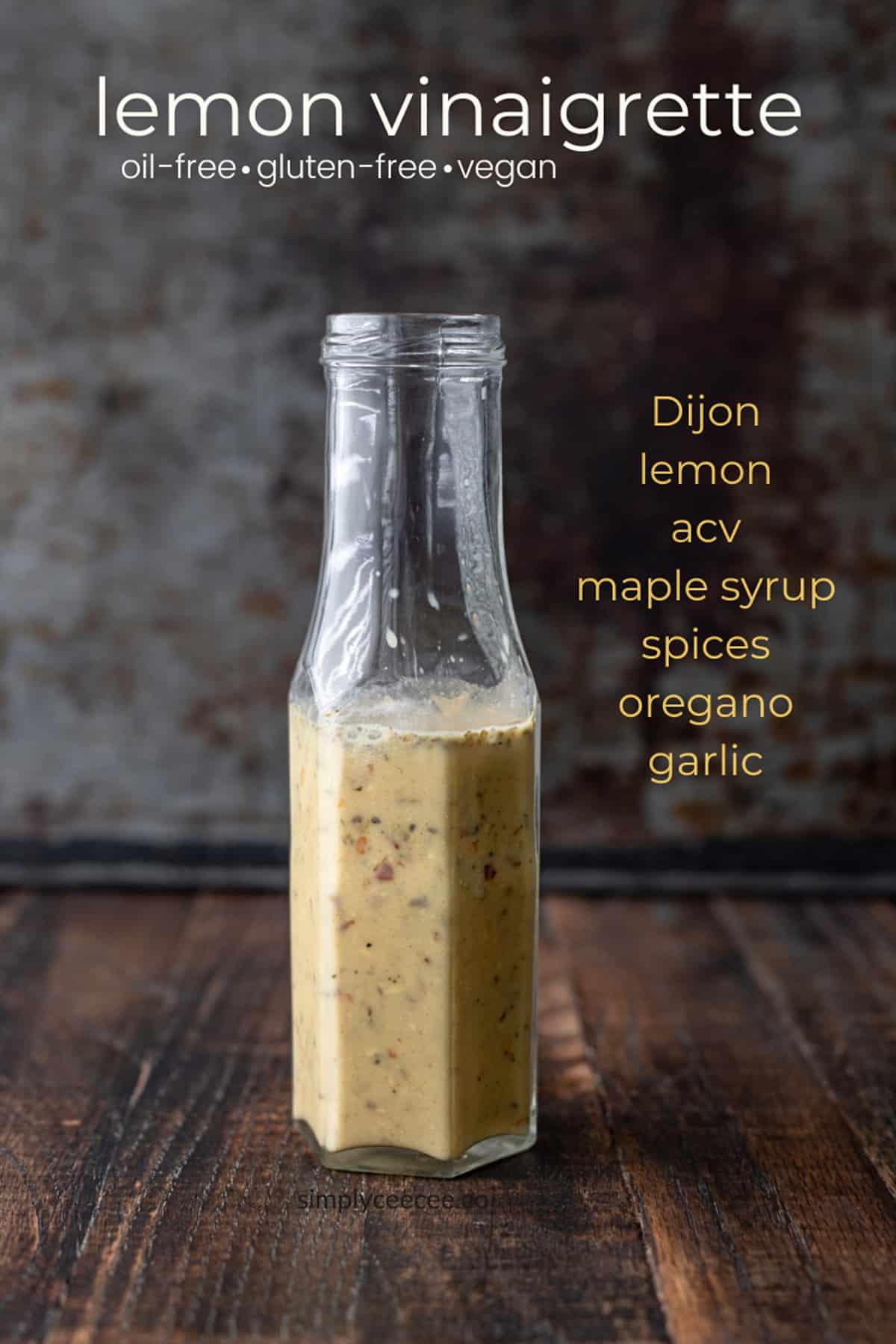 Tall jar of oil-free lemon vinaigrette dressing on counter.