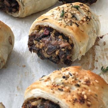 Vegan mushroom sausage rolls on a baking tray.