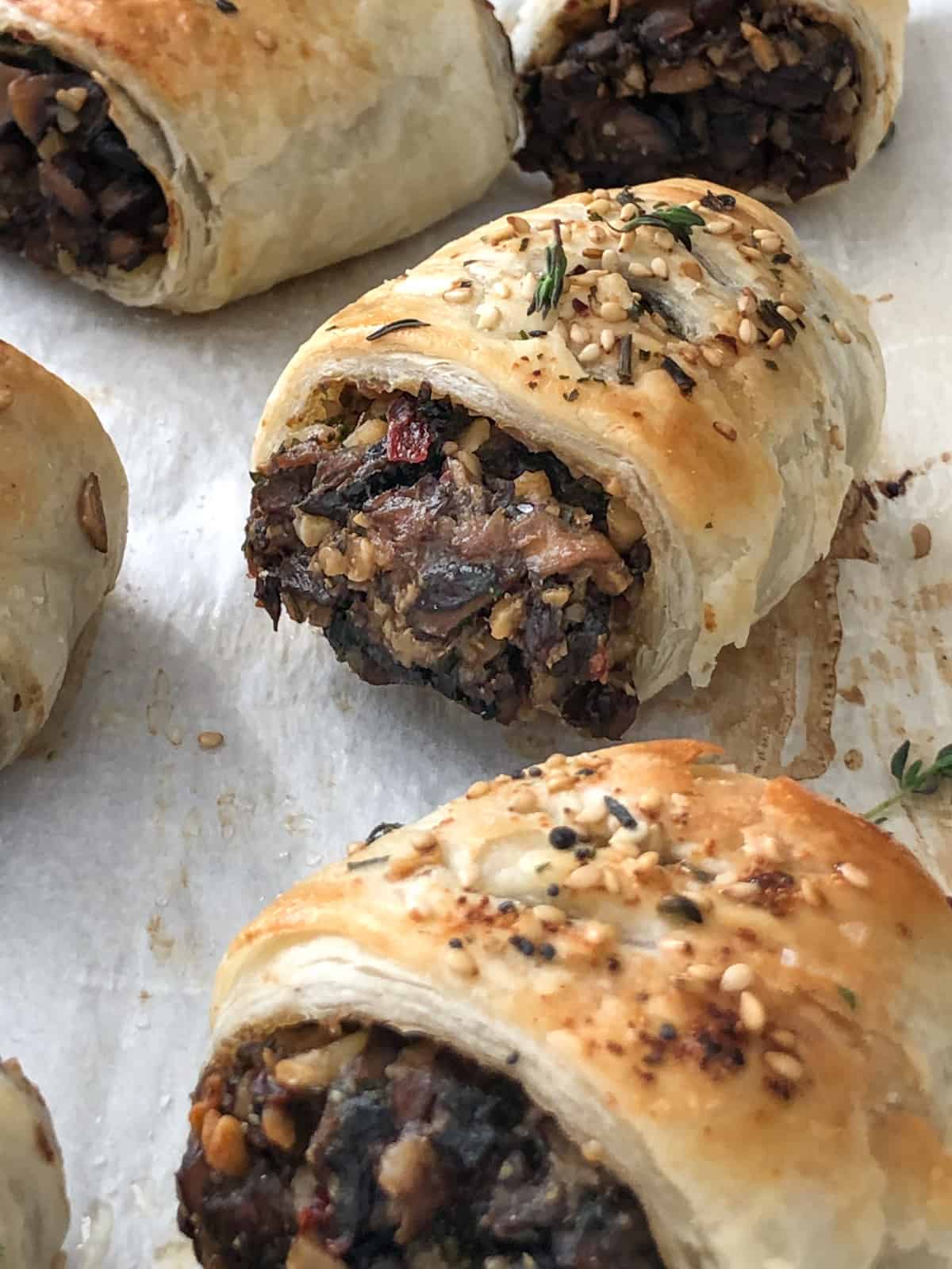 Vegan mushroom sausage rolls on a baking tray.