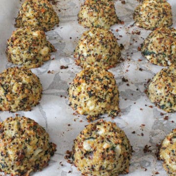 Cauliflower quinoa meatballs on a baking tray.