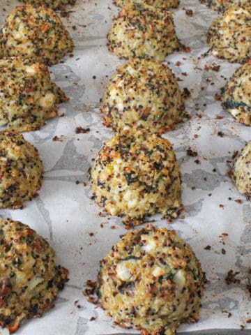 Cauliflower quinoa meatballs on a baking tray.