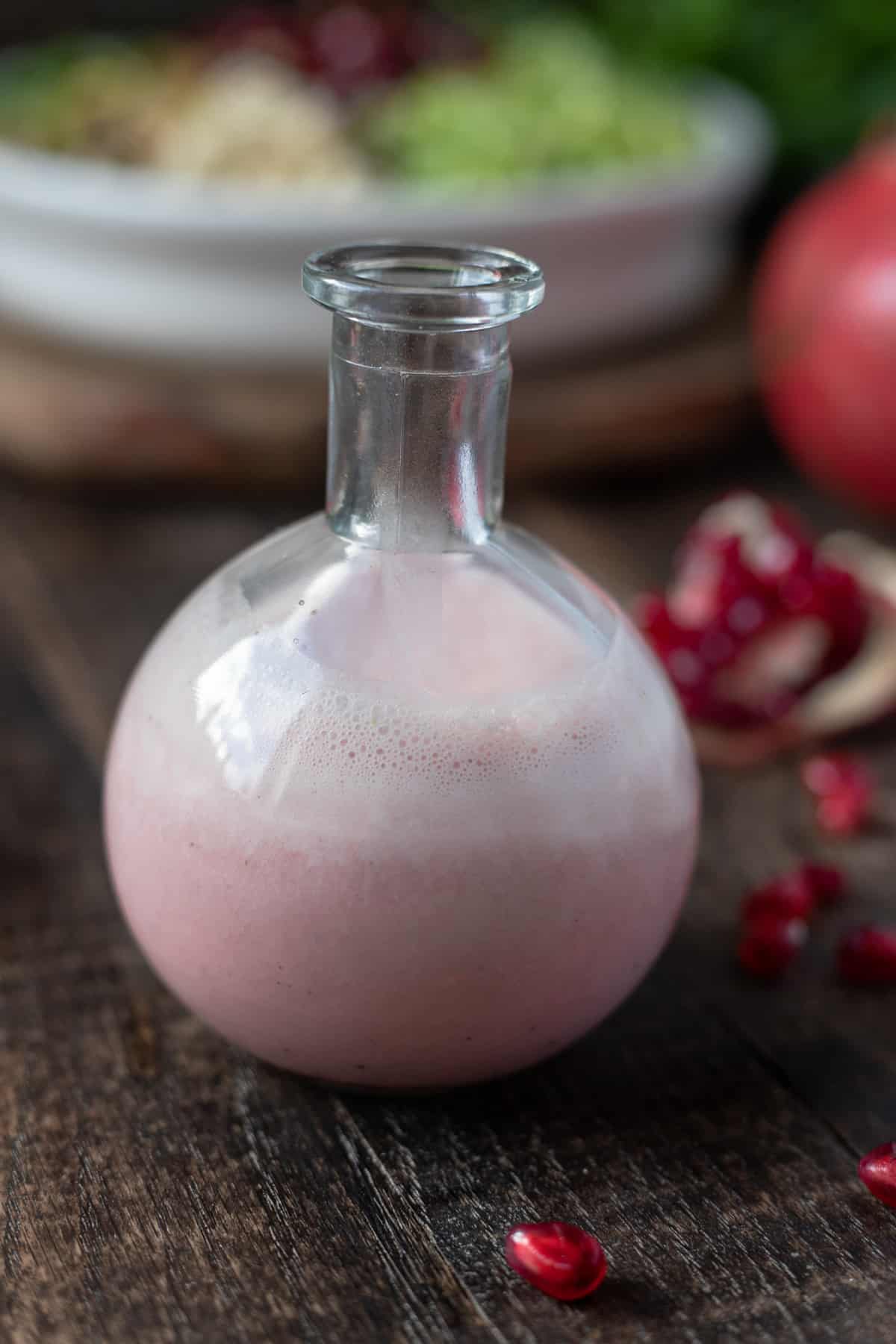 Jar of dairy-free pomegranate-balsamic vinaigrette.