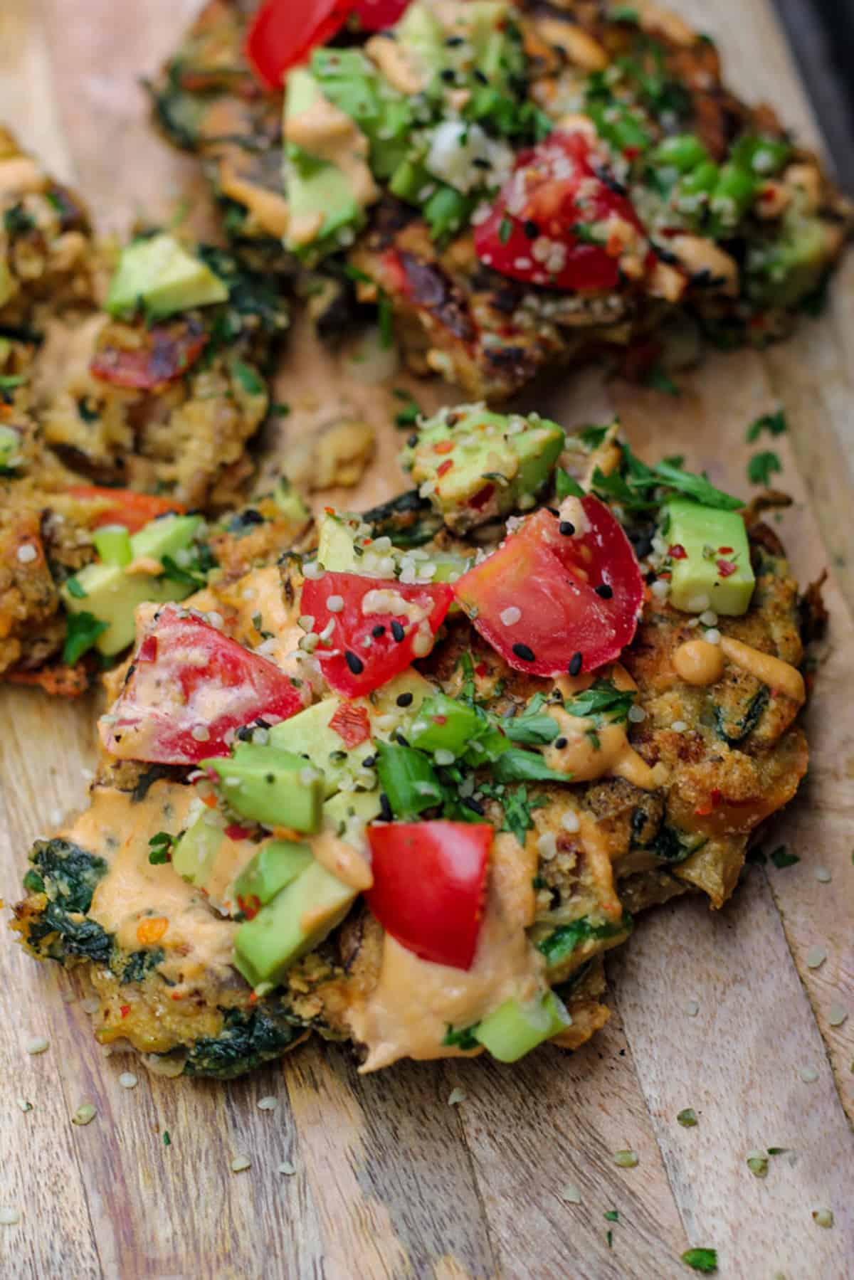 Chickpea pancakes topped with avocado and tomatoes.