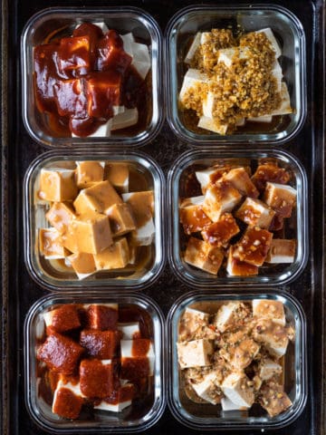 Bowls of tofu cubes marinating.