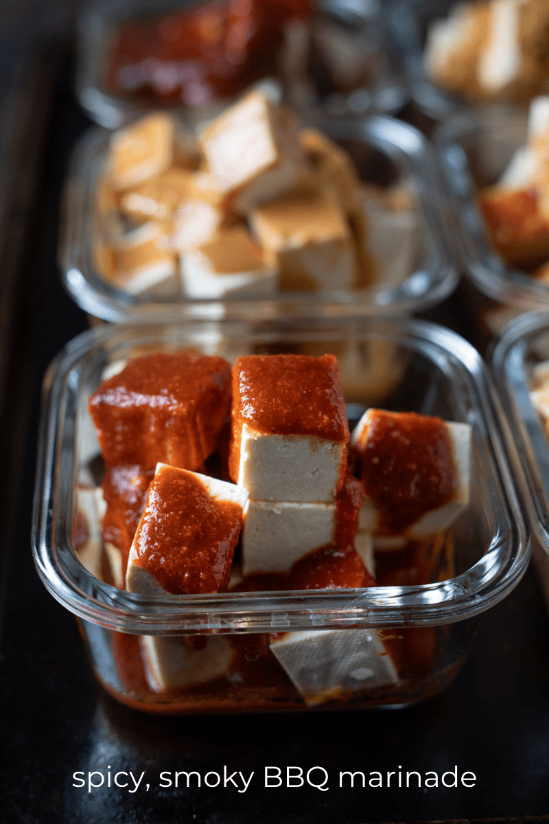 Tofu cubes marinating in bbq sauce.