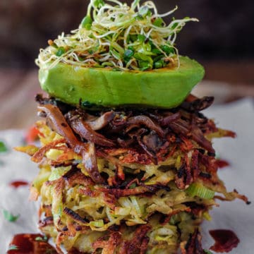 Potato Leek Pancake stack with spicy mushrooms and an avocado boat on top