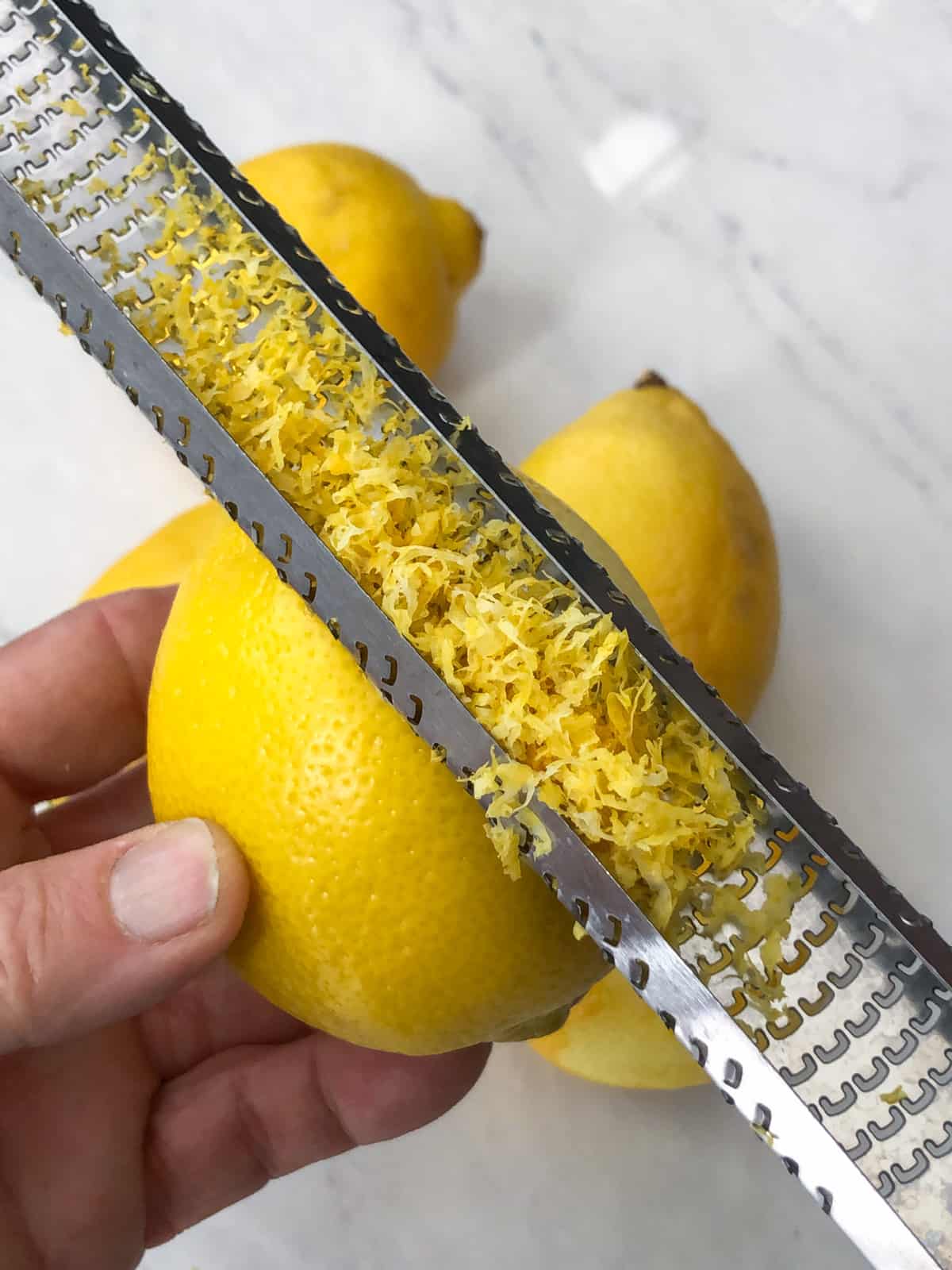 Lemon being zested on microplane.