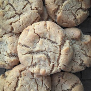 Pile of homemade peanut butter cookies on baking tray.