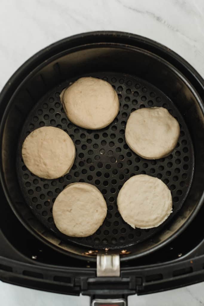 Air fryer biscuit dough in the air fryer.