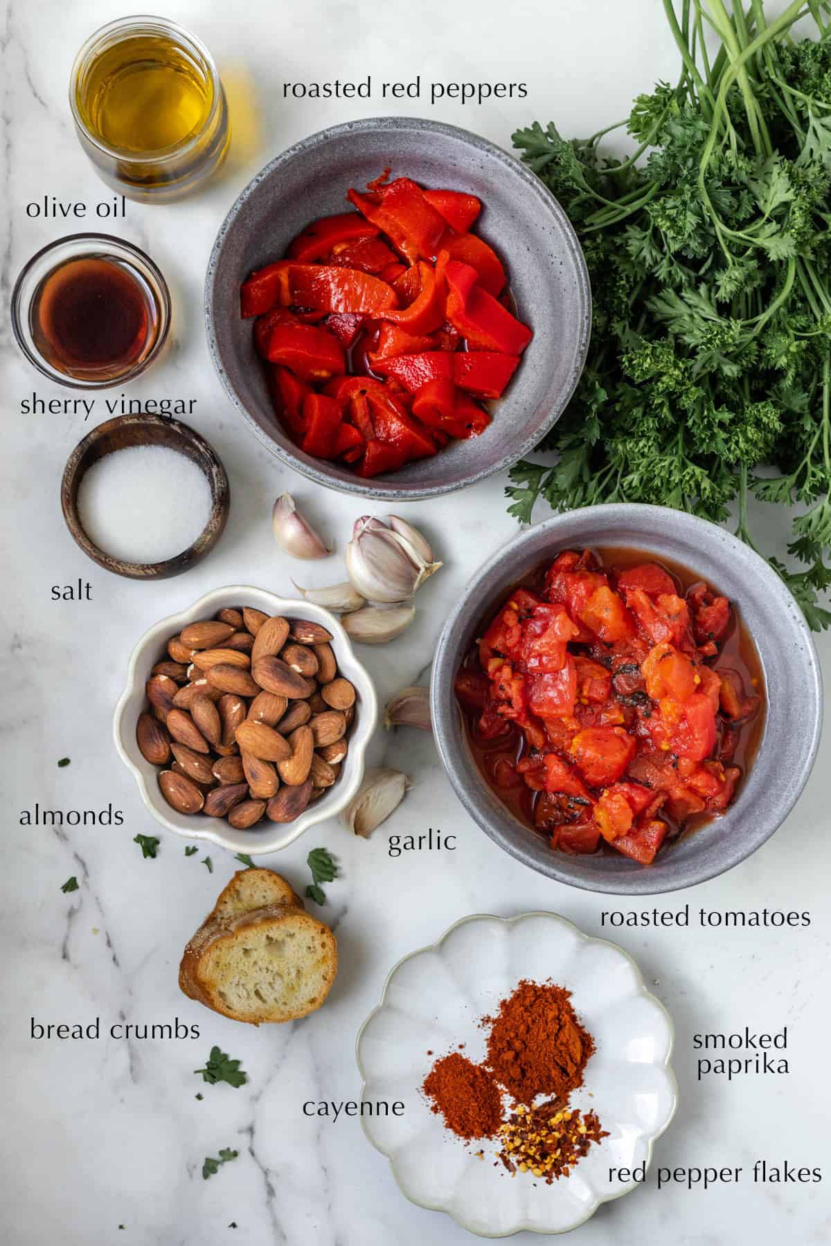 Ingredients for homemade romesco sauce in individual bowls.