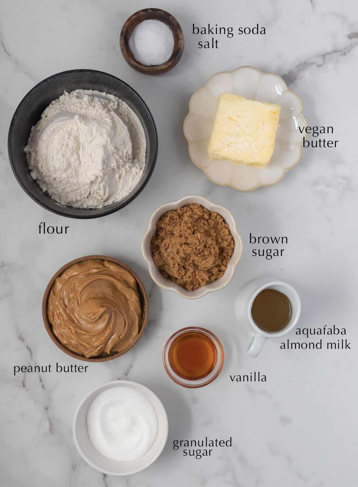 Ingredients for eggless peanut butter cookies laid out on counter.