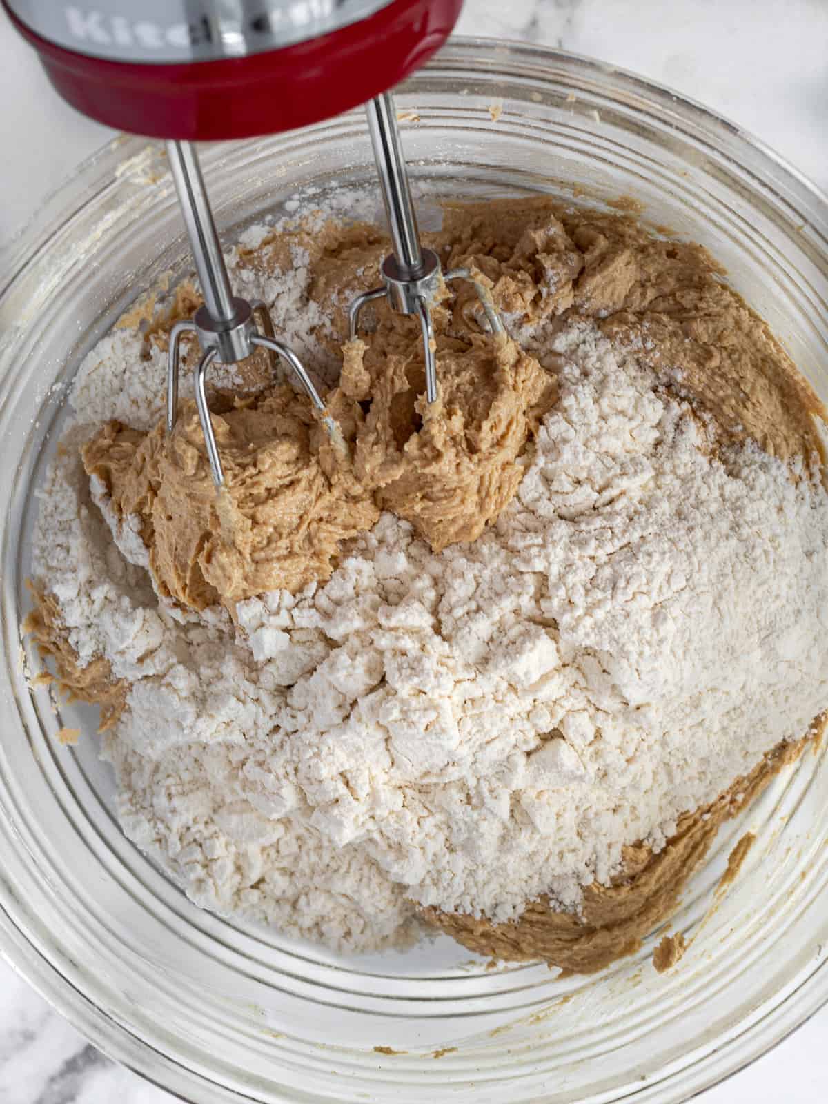 Creamed peanut butter and butter, sugar and flour in a mixing bowl.