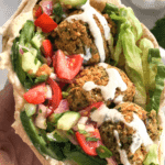 Falafel balls, tomatoes and cucumbers in a pita pocket.