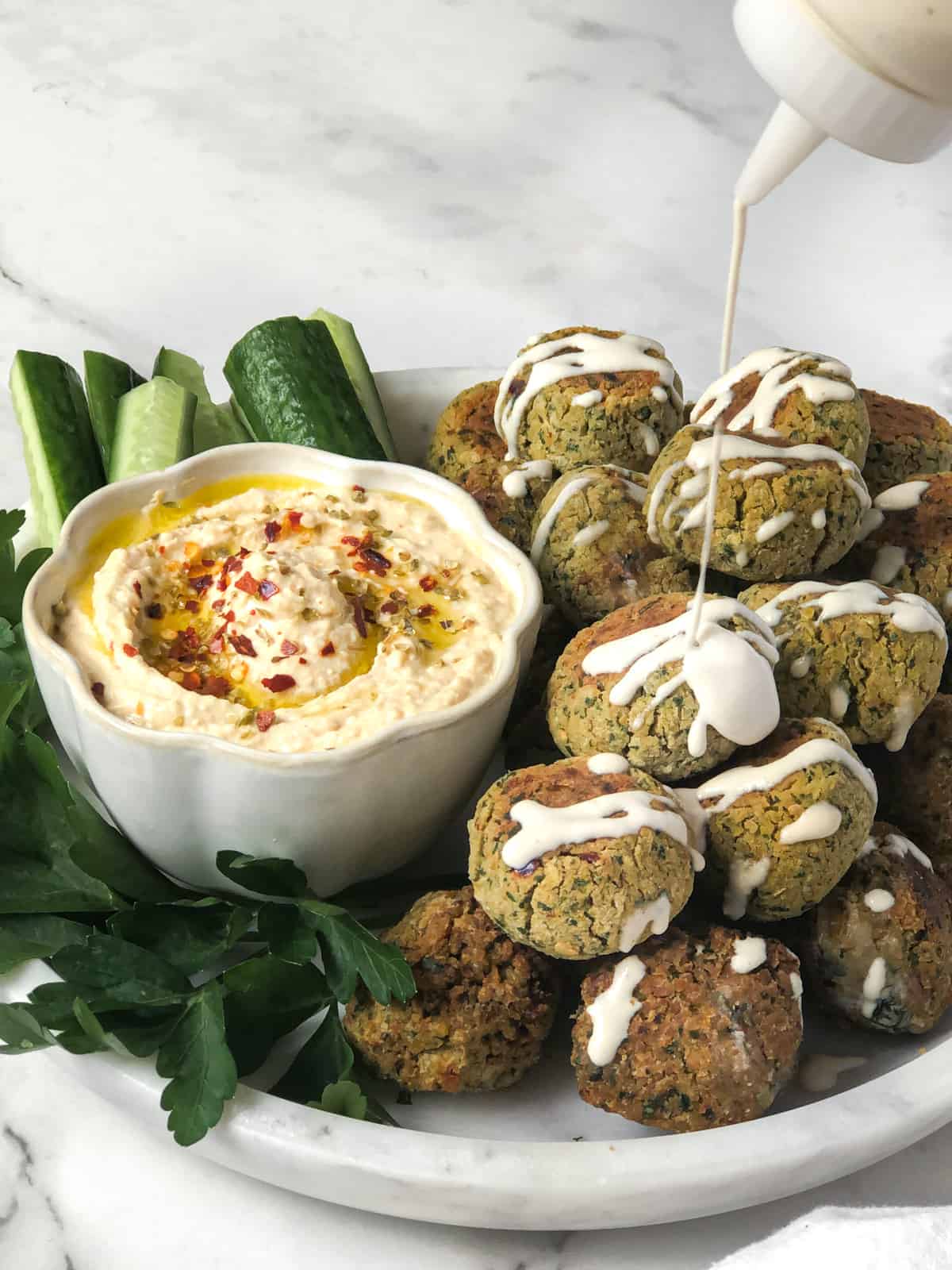 Falafel plate with hummus and tahini.