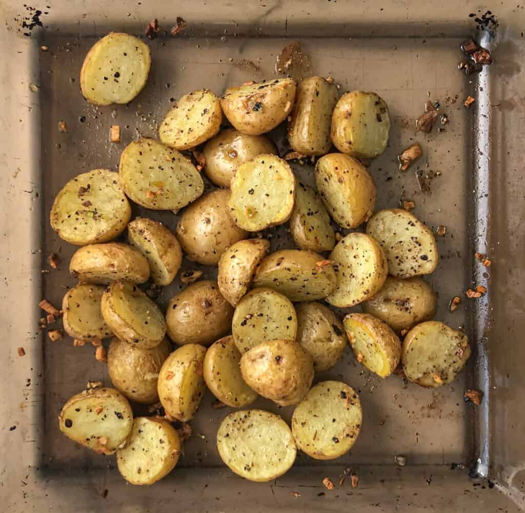 Crispy roasted garlic potatoes in a baking dish.