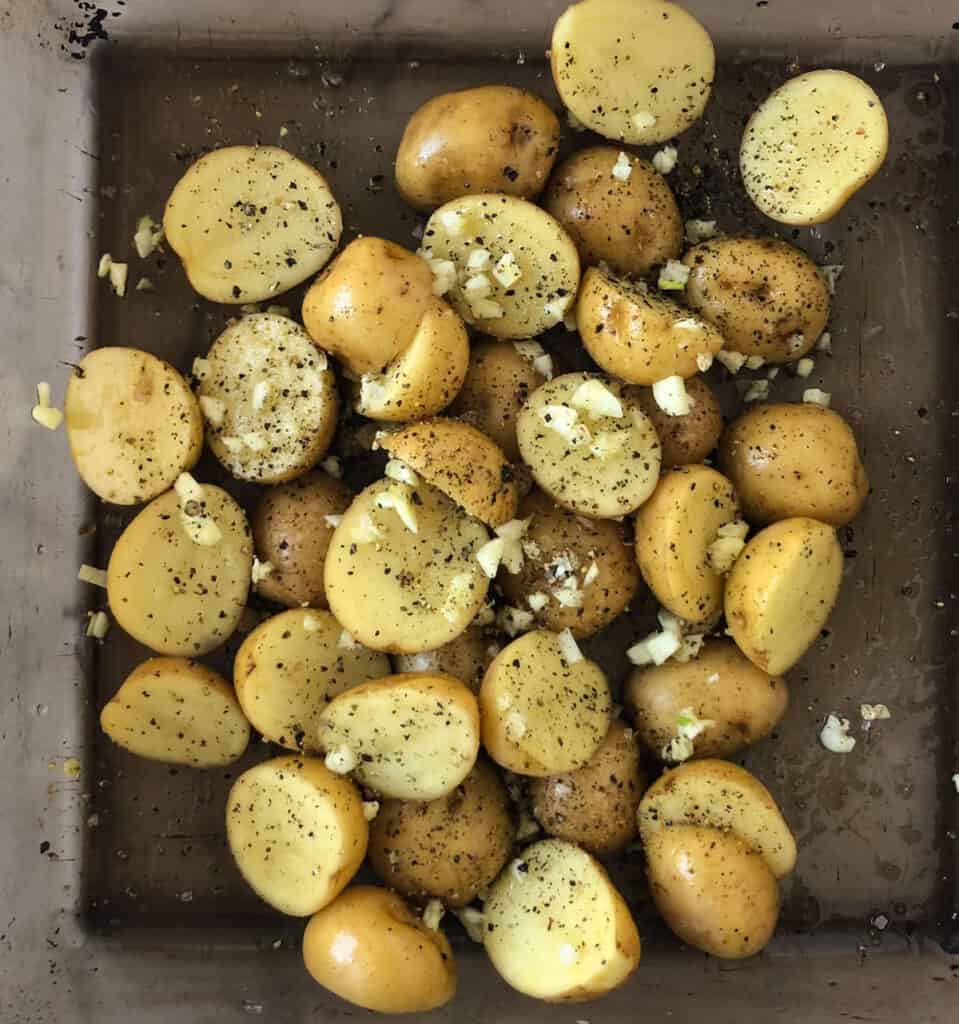 Potatoes and garlic in a baking dish.