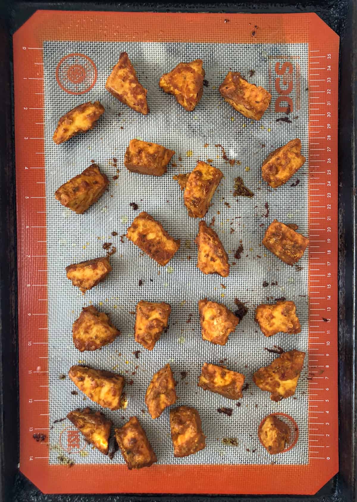 Cooking tray with spicy baked tofu nuggets.