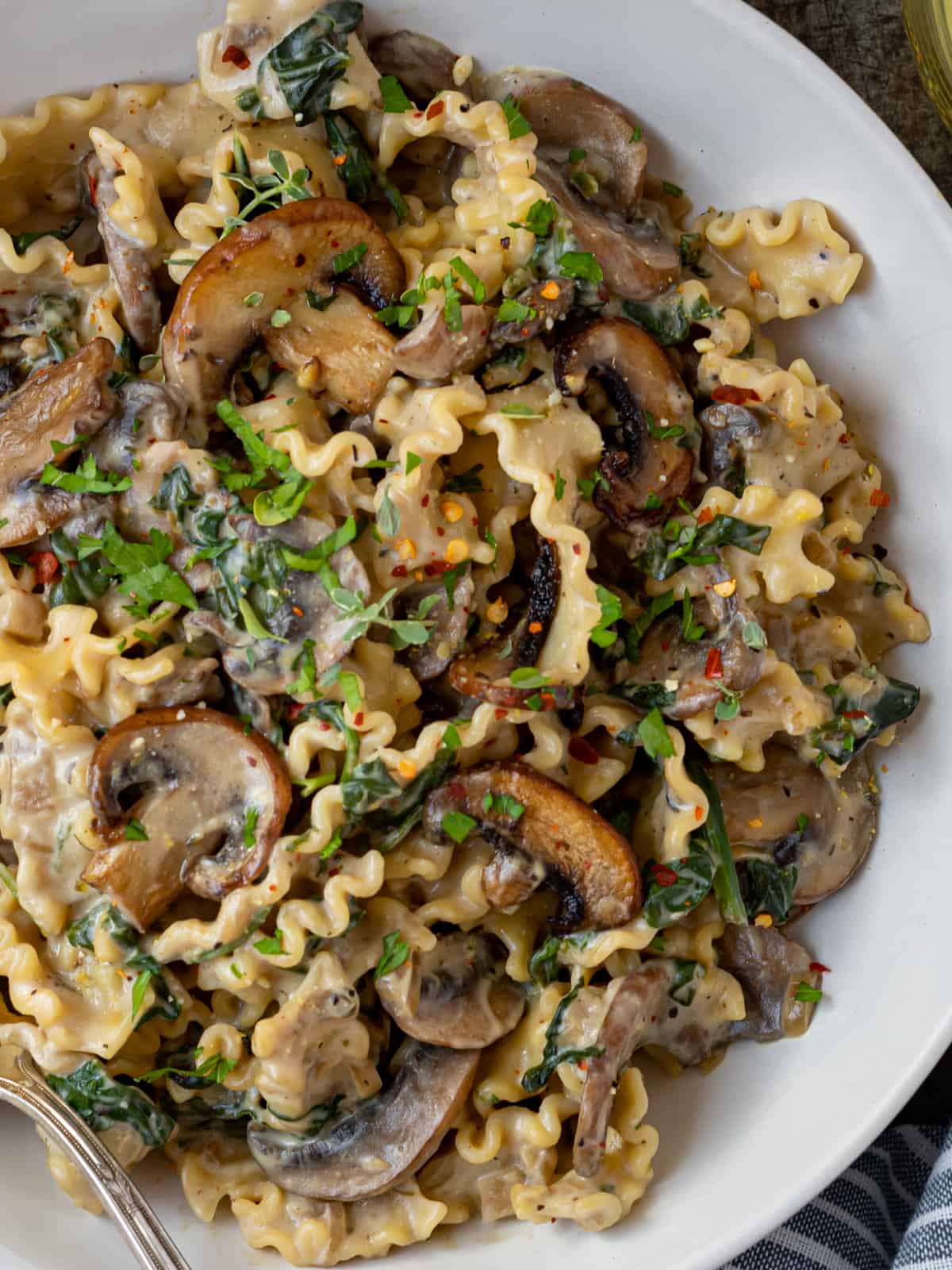 Bowl of mushroom and spinach pasta.